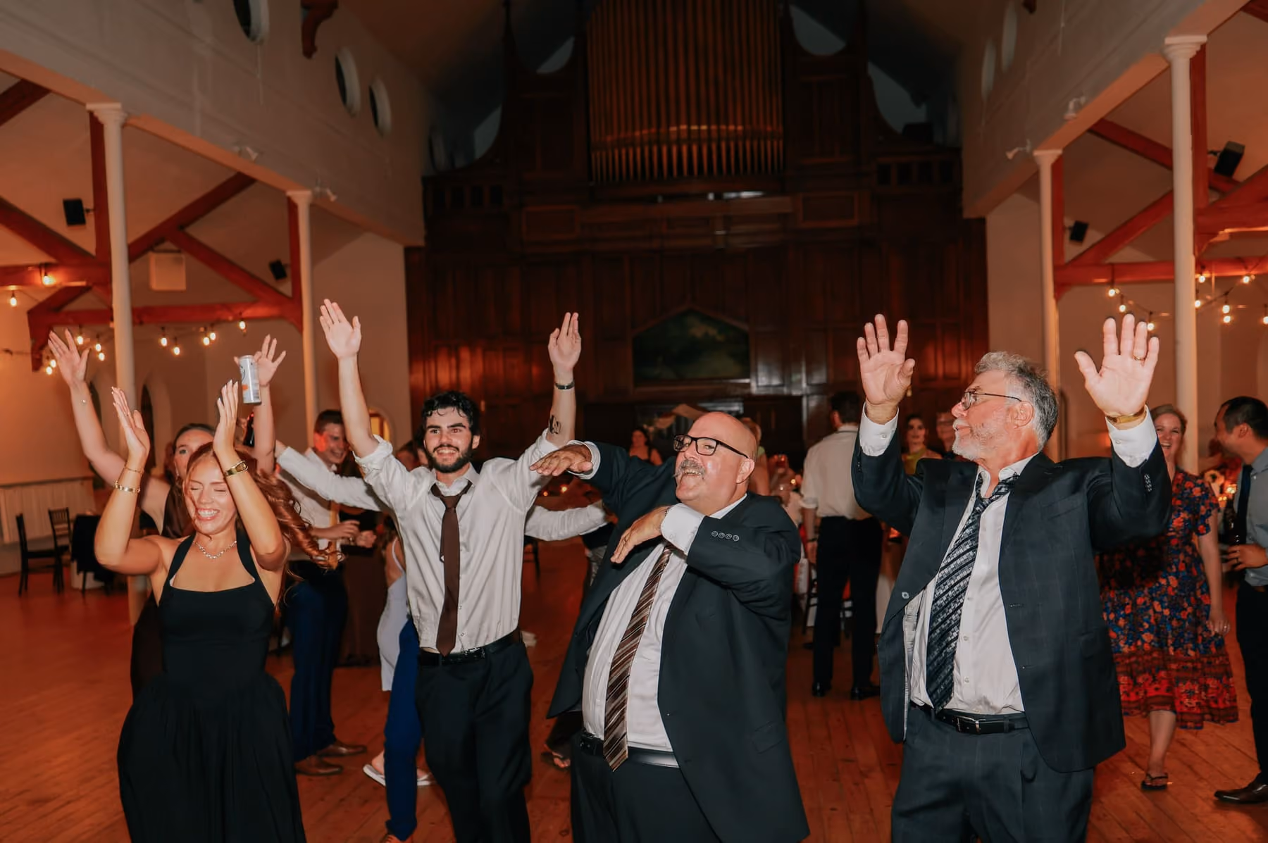 Guests throw their hands up on the dance floor.